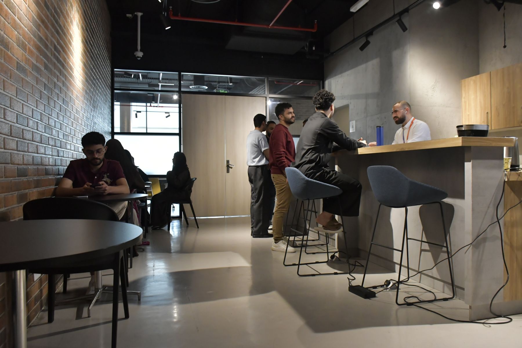 Members talking at the café bar